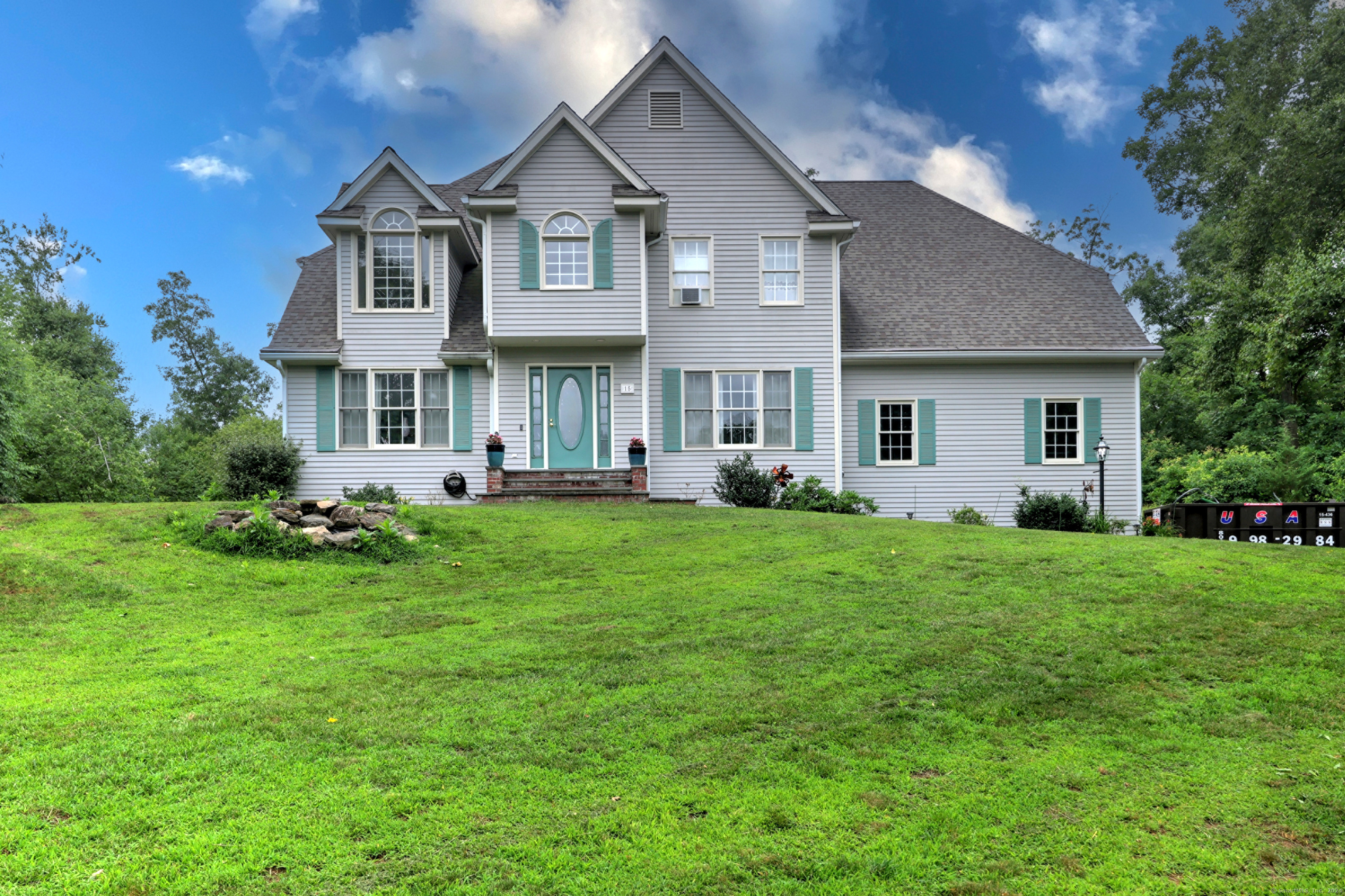 a front view of house with yard and green space