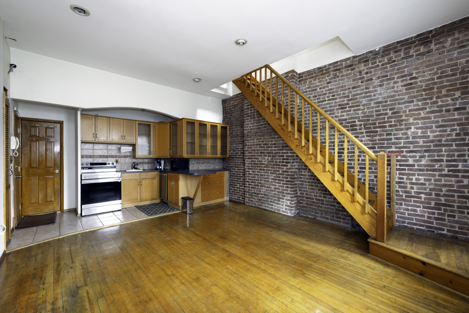 a view of kitchen with wooden floor and electronic appliances