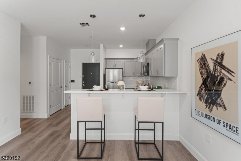 a kitchen with stainless steel appliances granite countertop a white cabinets and a stove top oven