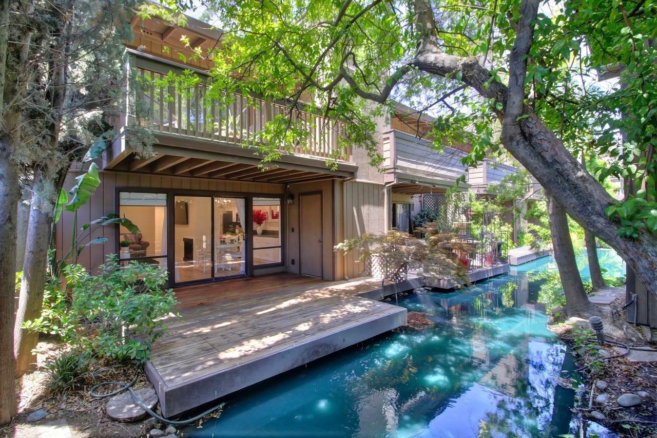 a view of a house with backyard and sitting area