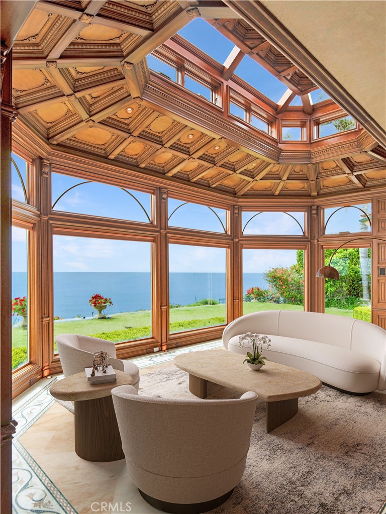 a living room with furniture and floor to ceiling windows