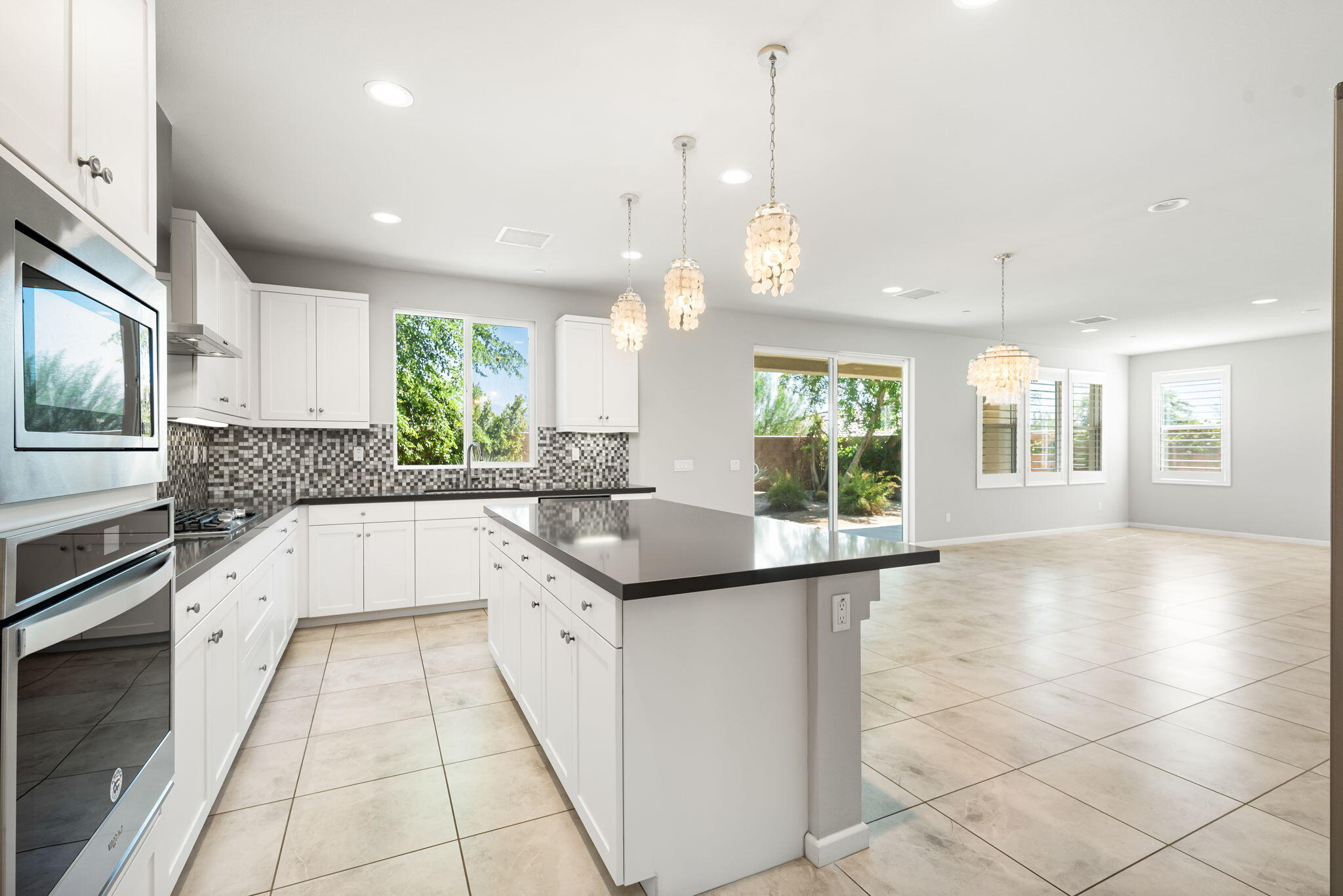 a large white kitchen with a large window