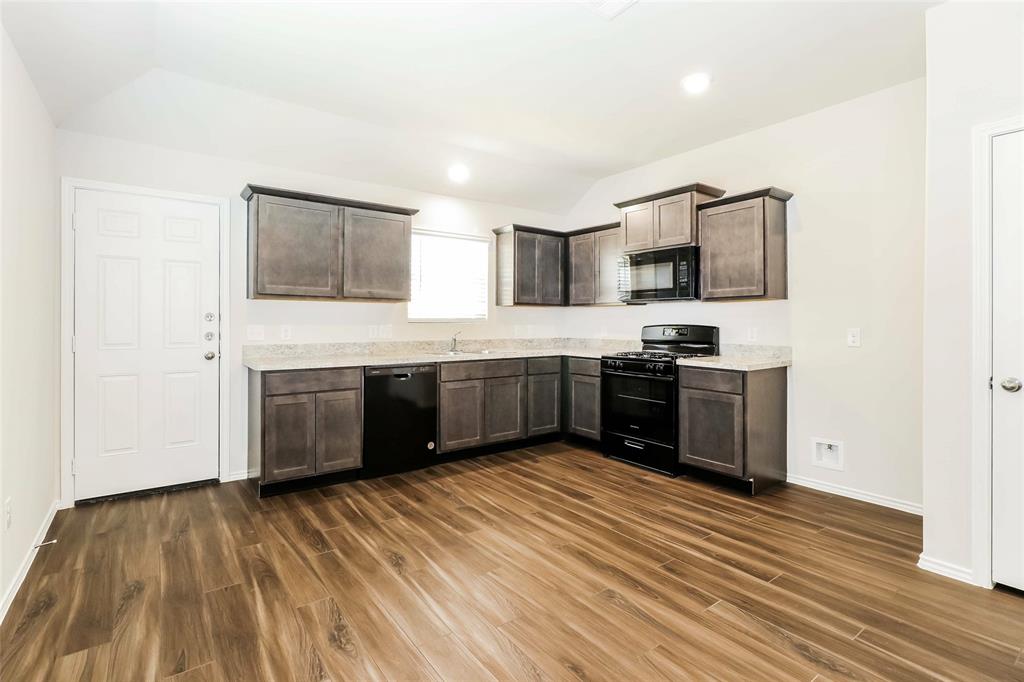 a kitchen with stainless steel appliances a sink and a refrigerator