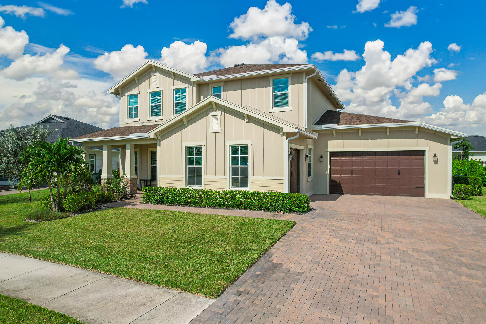 a front view of a house with a yard and garage