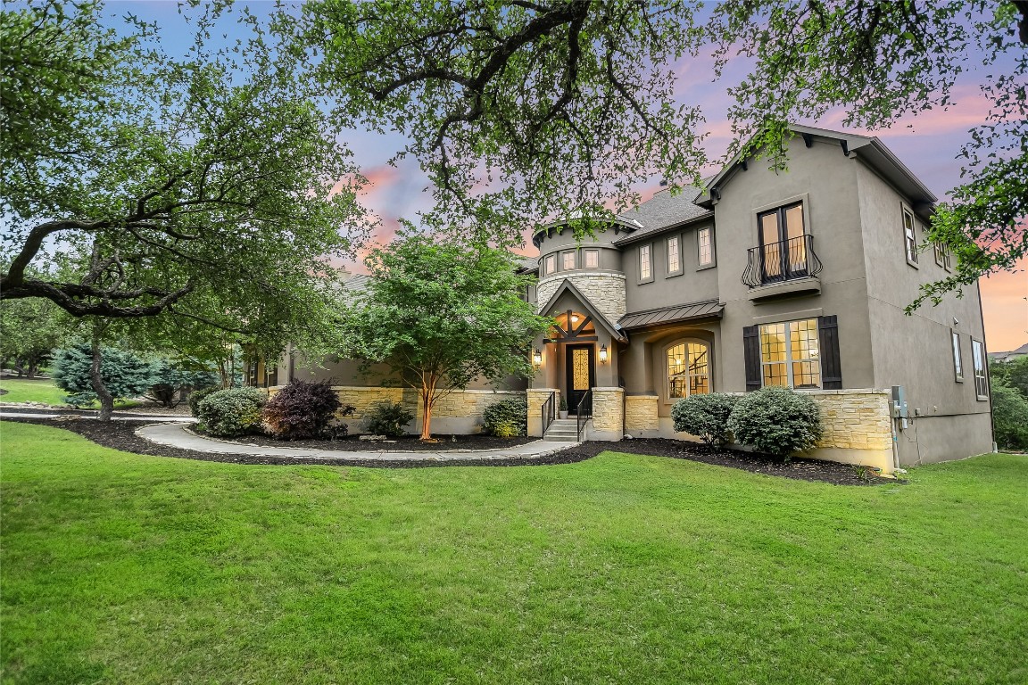 a view of a house with a yard and sitting area