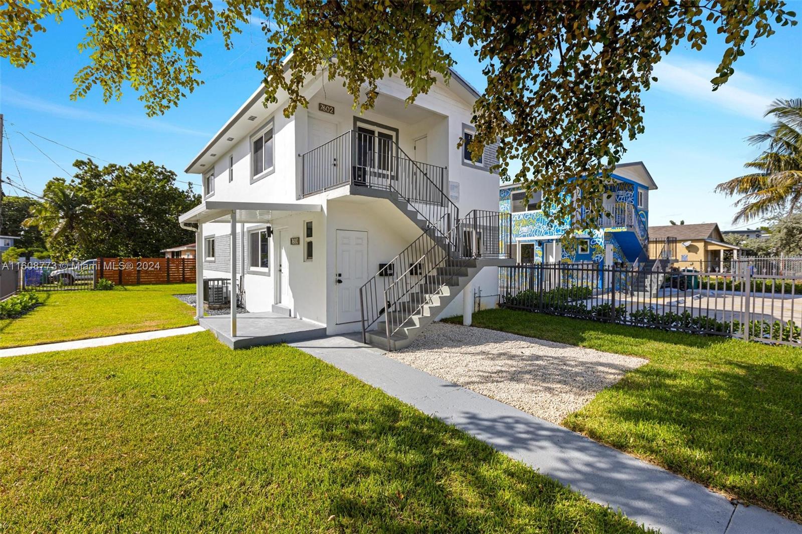 a view of a house with backyard and sitting area