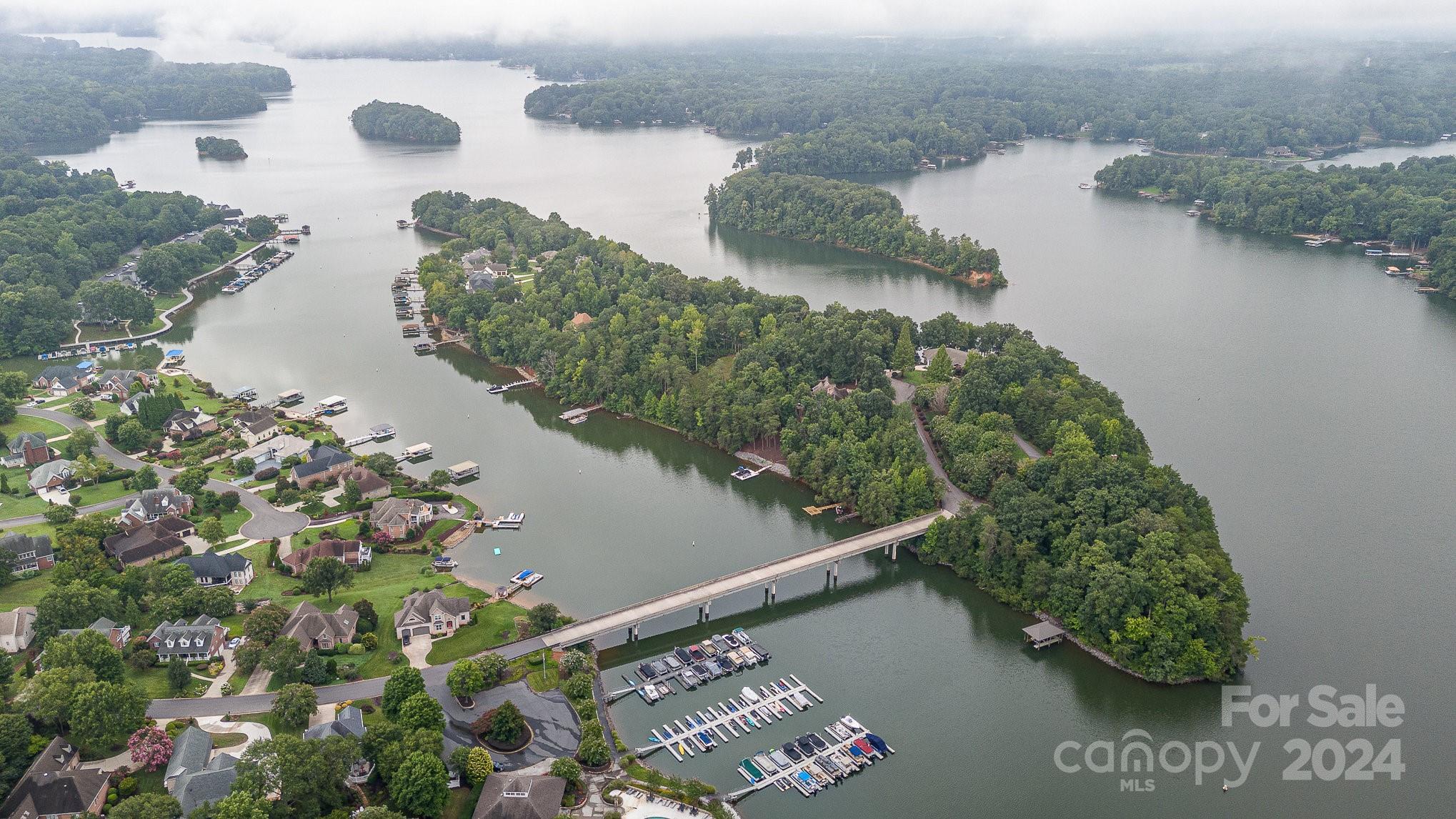 an aerial view of a house a yard and a lake view