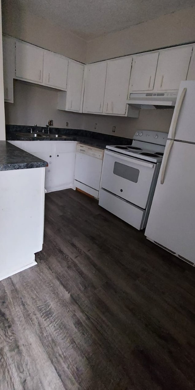 a kitchen with granite countertop a stove and a sink