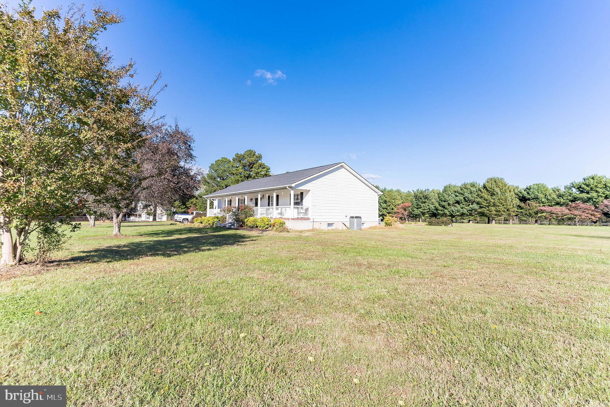 a view of an house with backyard space and lake view