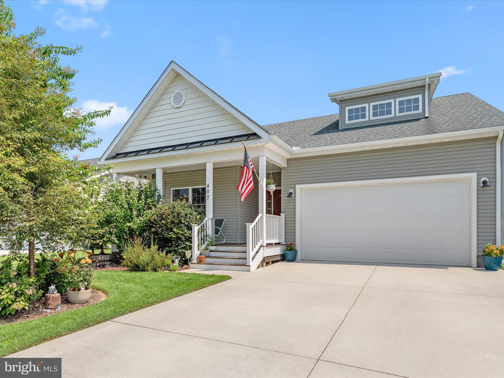 a front view of house with yard and trees in the background