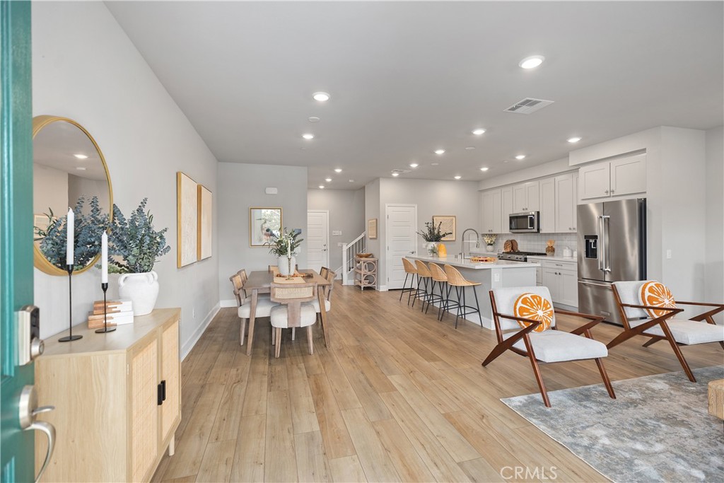 Modern open concept ambiance as you enter this home. Designer wide plank luxury vinyl flooring, recessed lighting, light and bright throughout.