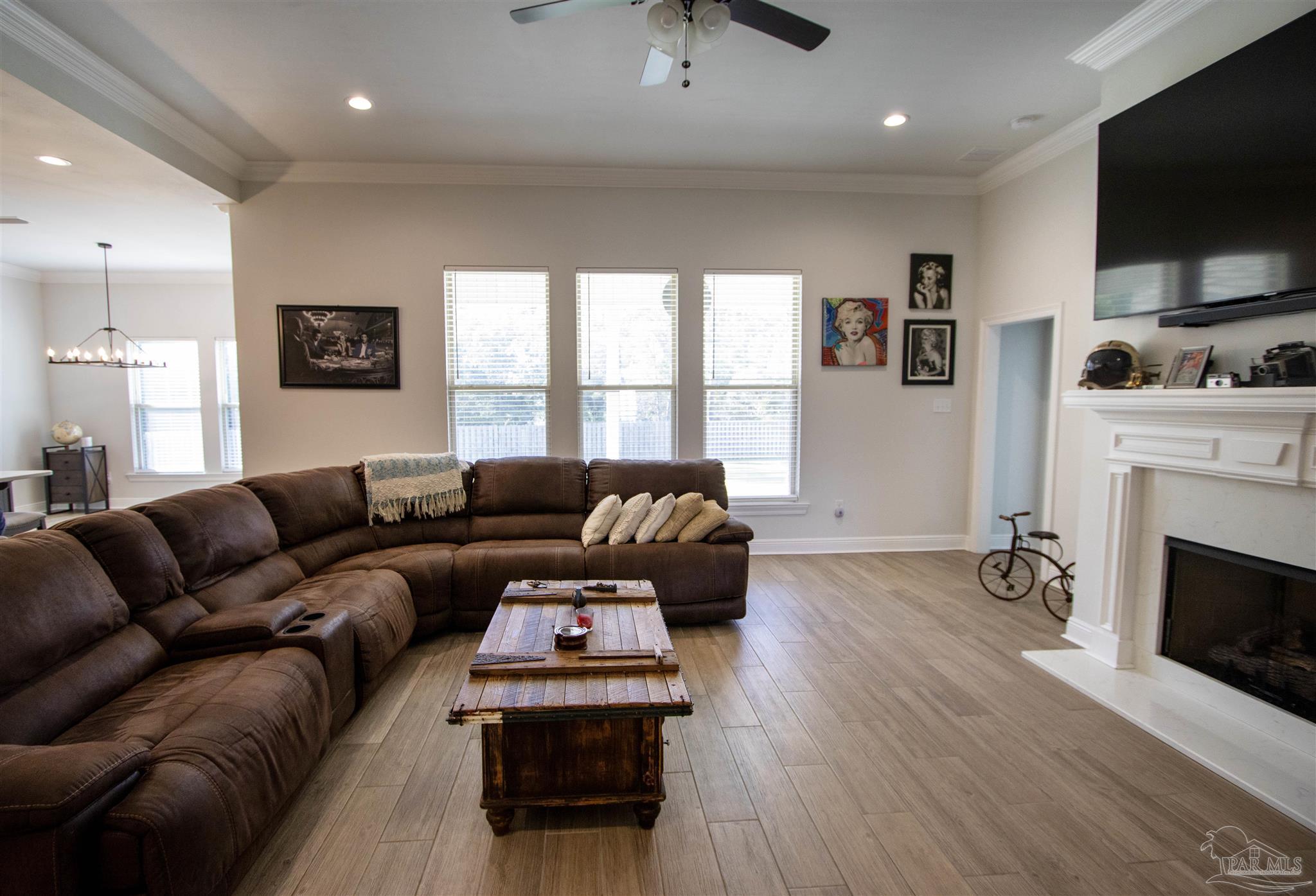 a living room with furniture a flat screen tv and a fireplace