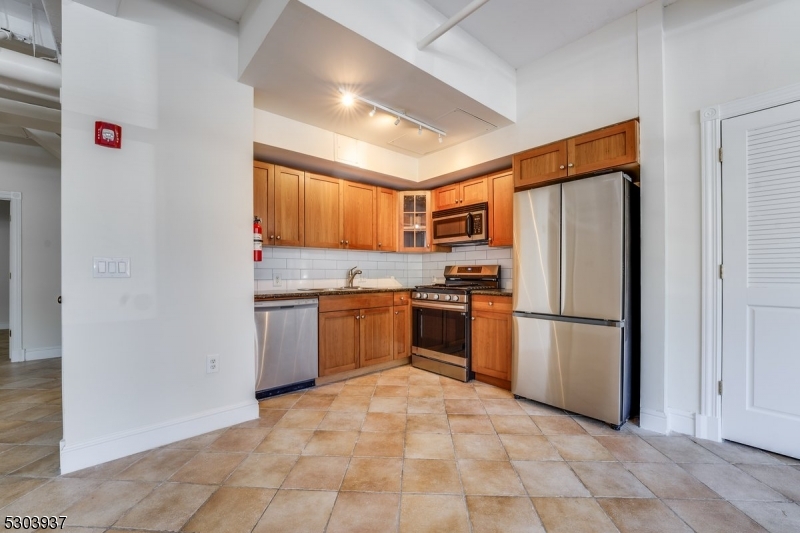 a kitchen with a refrigerator sink and stove