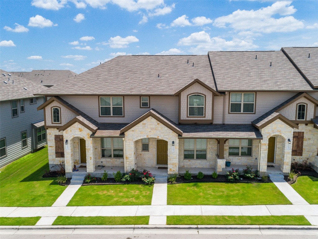 a front view of a house with a yard