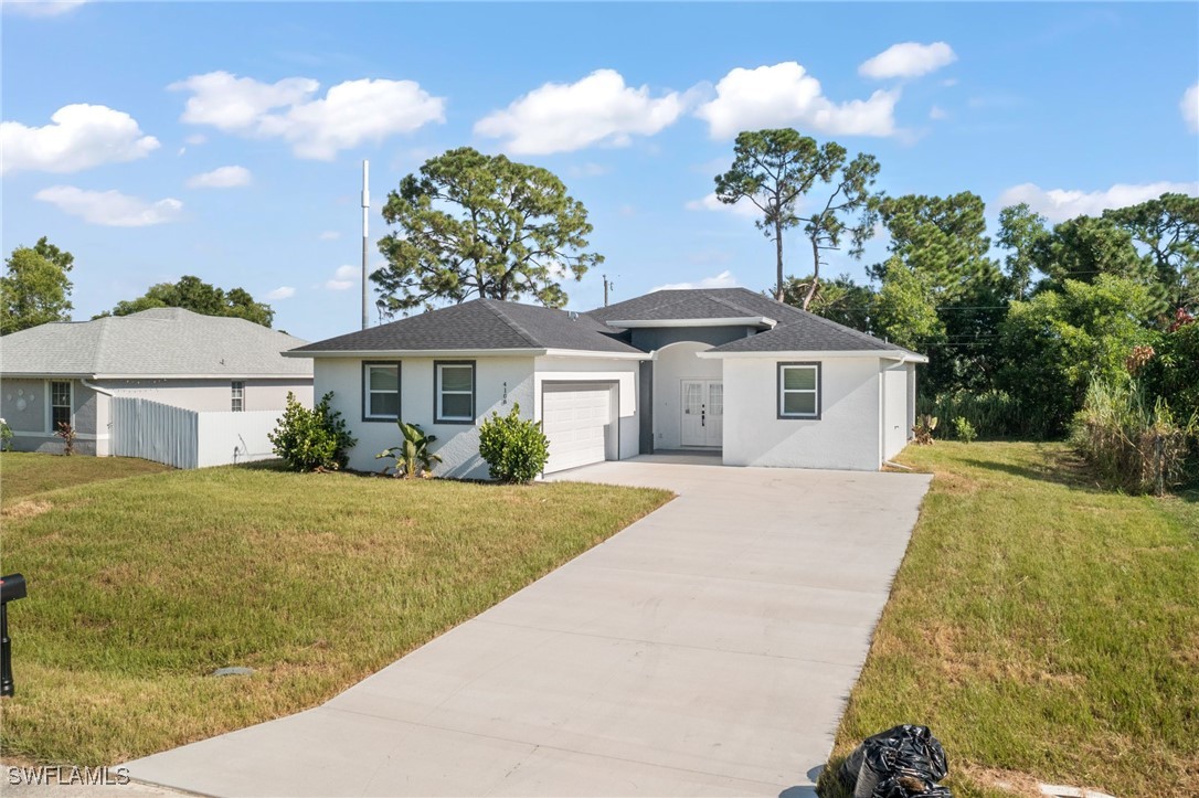 a front view of a house with a yard and garage