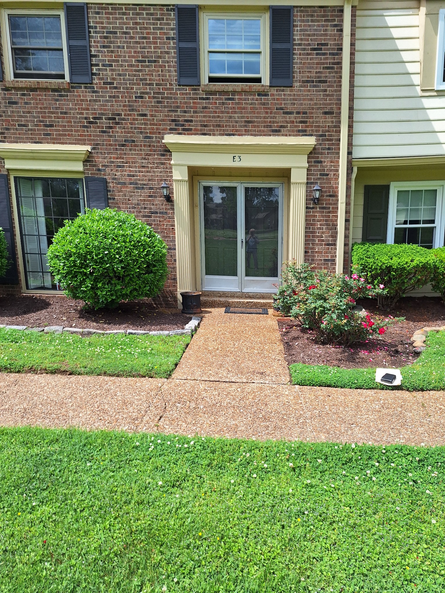 a front view of a house with a garden and plants