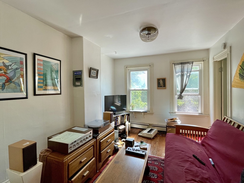 a livingroom with workspace couch and a window