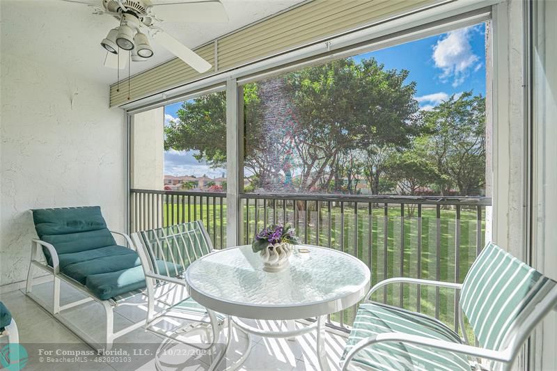 a balcony with a table and chairs