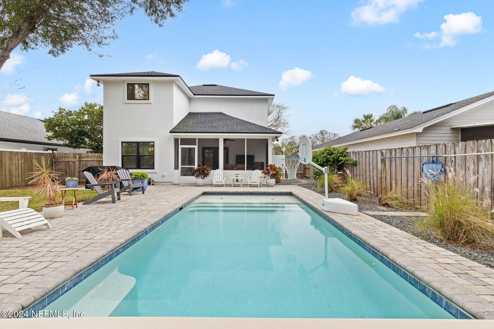 a view of a house with swimming pool and sitting area