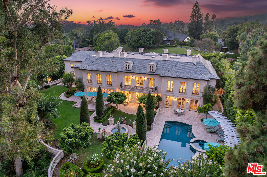 an aerial view of a house with garden space and street view