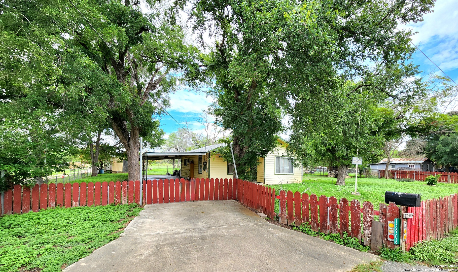 a view of backyard with deck and a garden