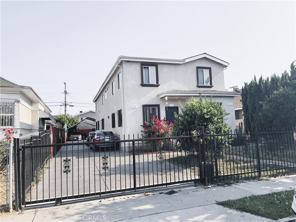 a view of a house with wooden fence