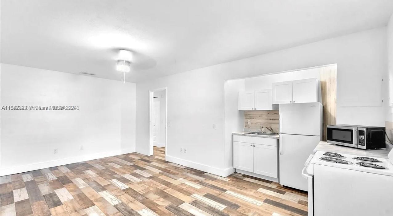 a kitchen with a stove and a refrigerator