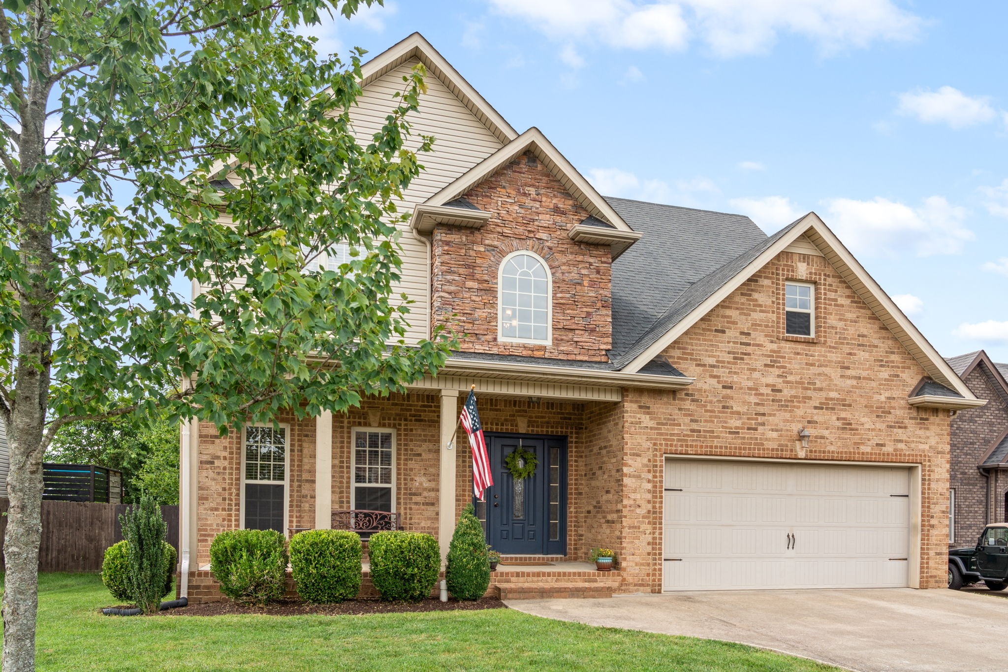 a front view of a house with a yard and garage