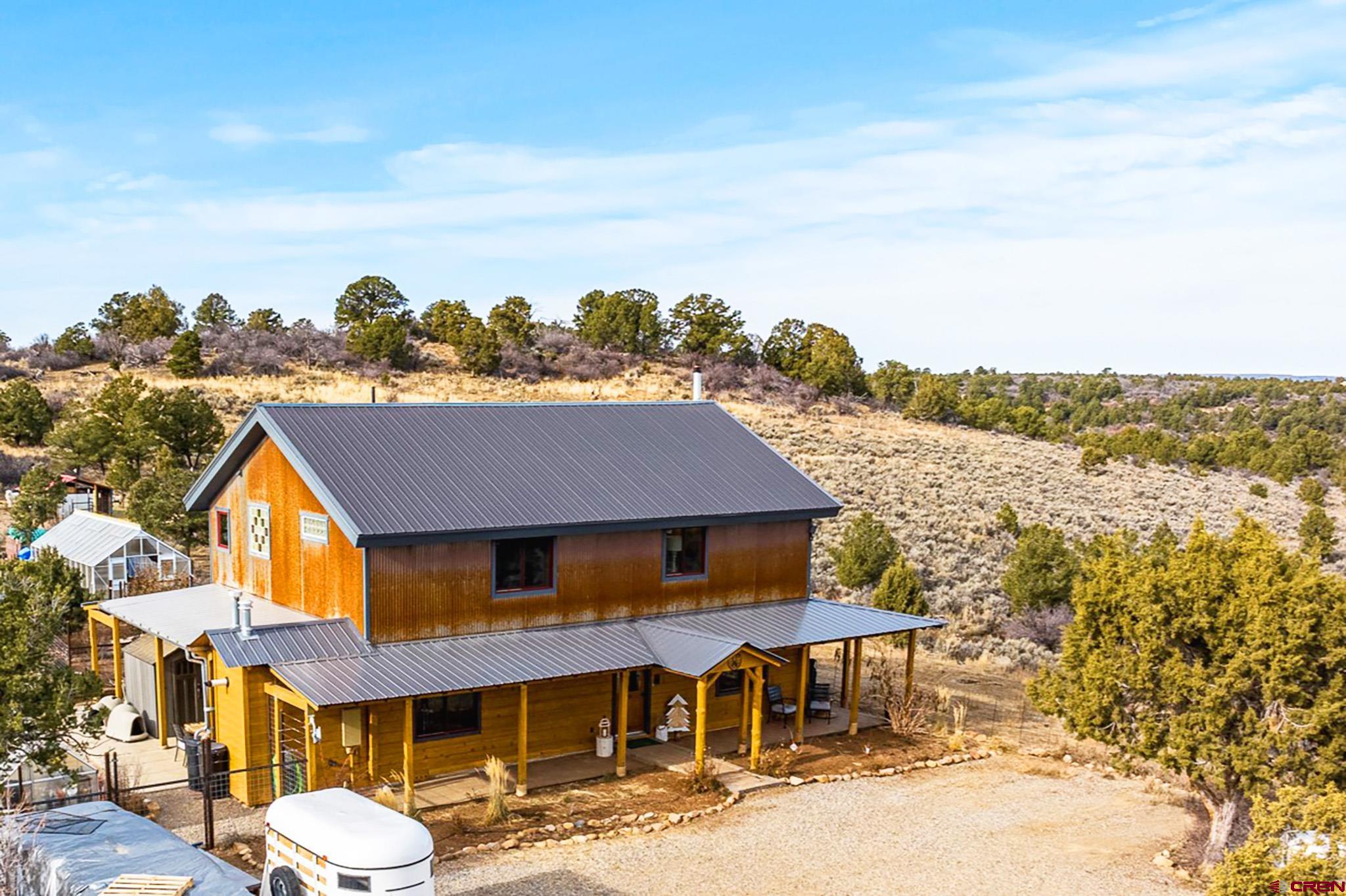 a aerial view of a house next to a yard