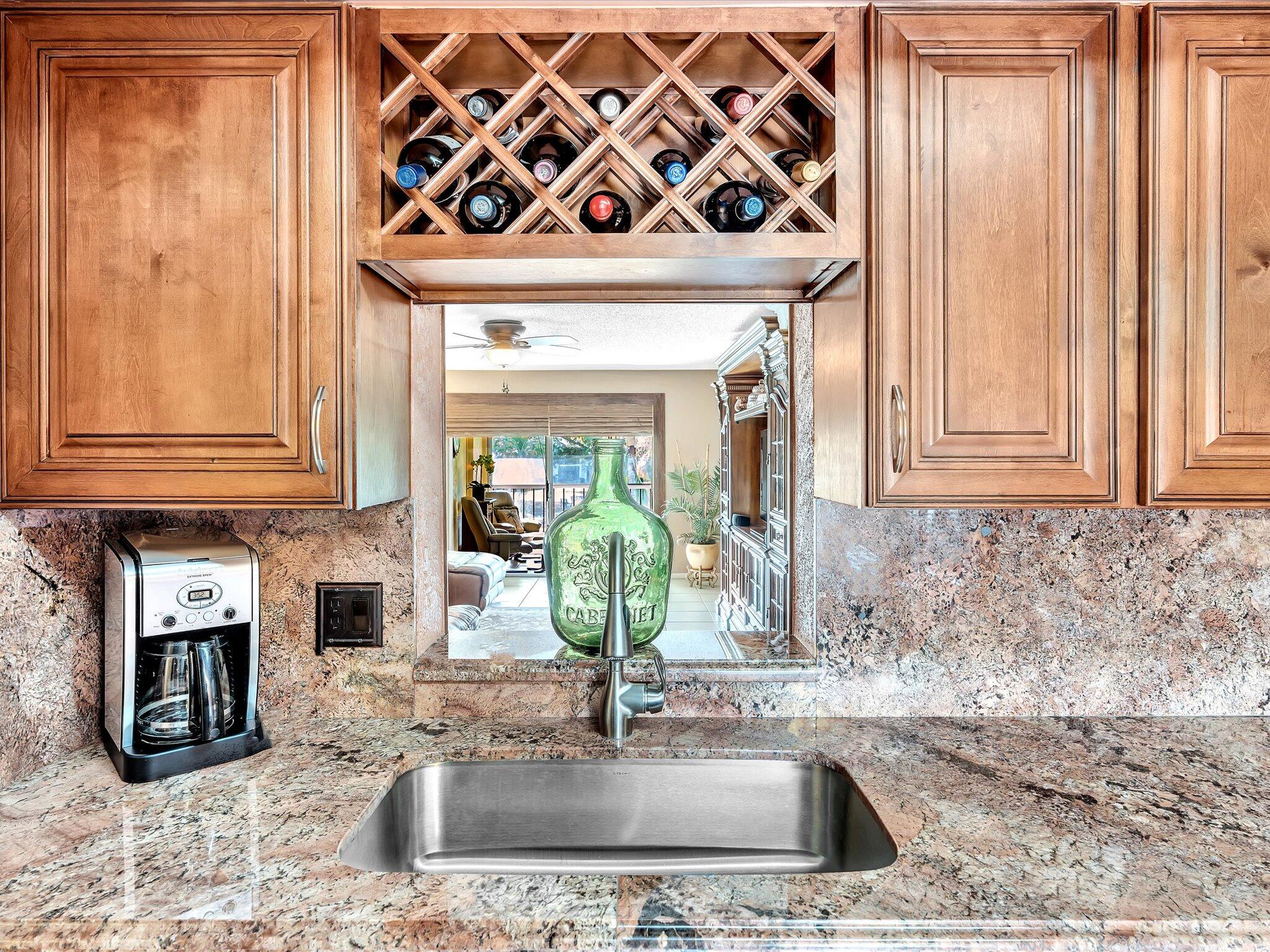 a kitchen with stainless steel appliances granite countertop a sink and a window