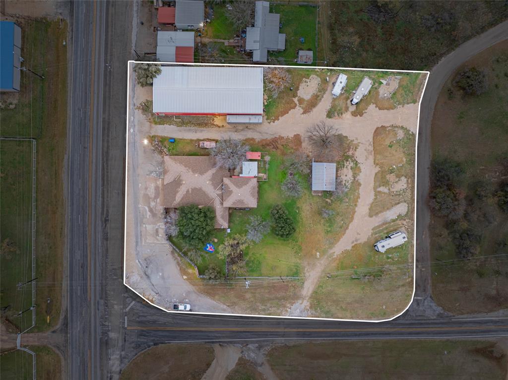 an aerial view of a residential houses with outdoor space