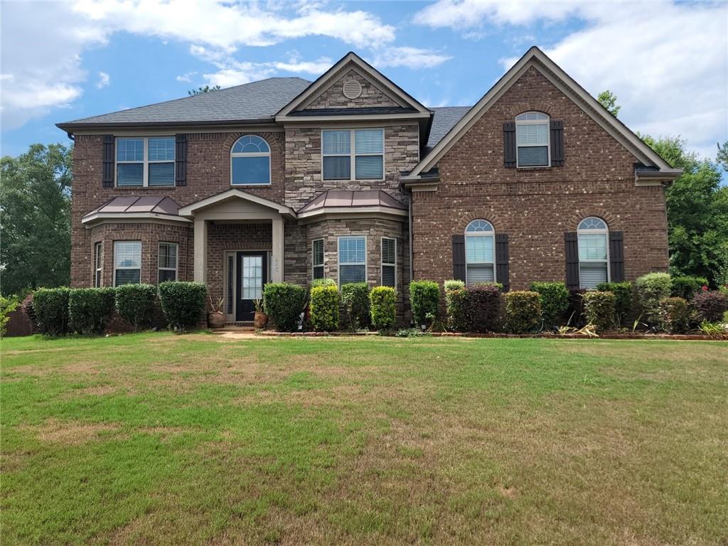 a front view of a house with a yard