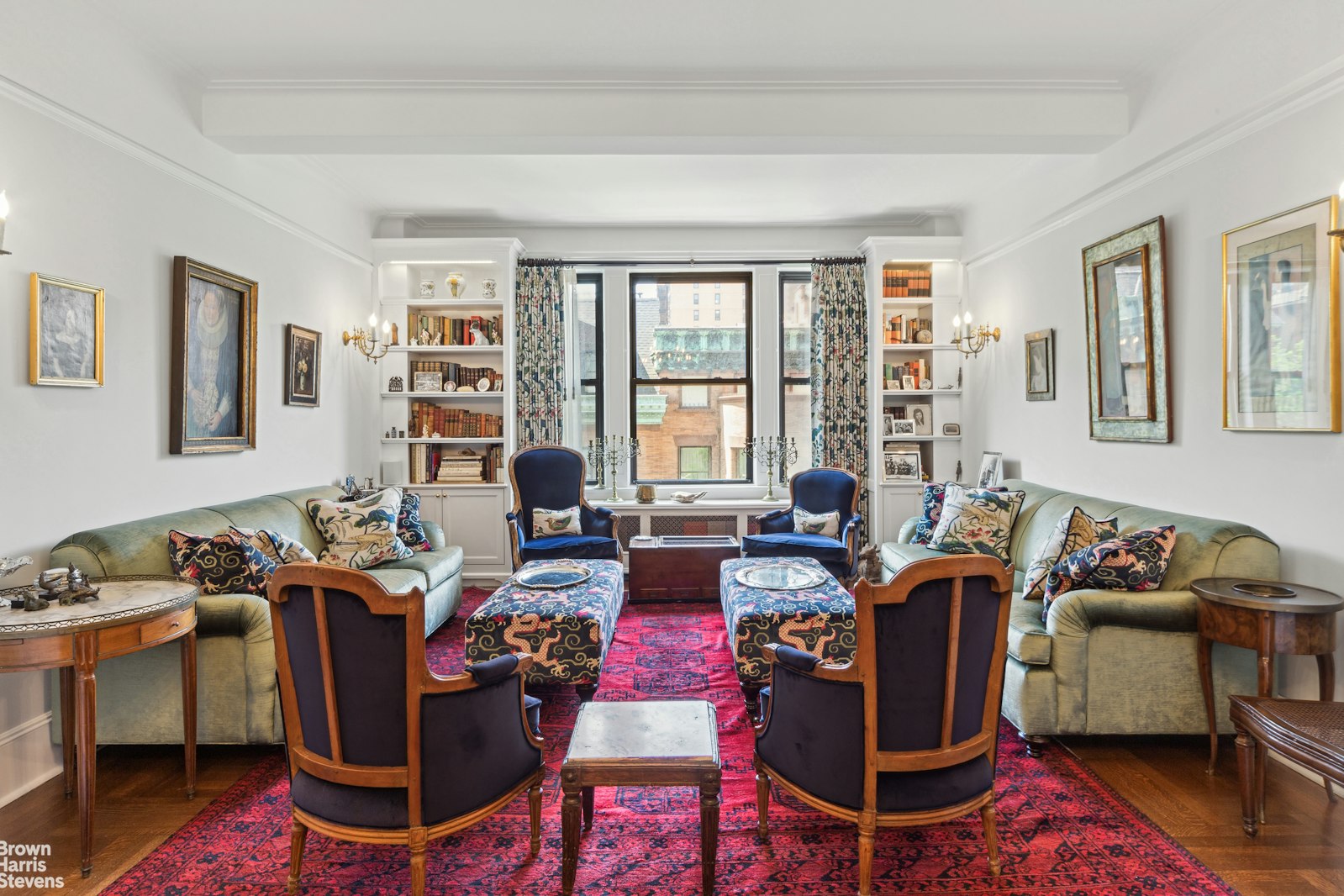 a living room with furniture fireplace and a window