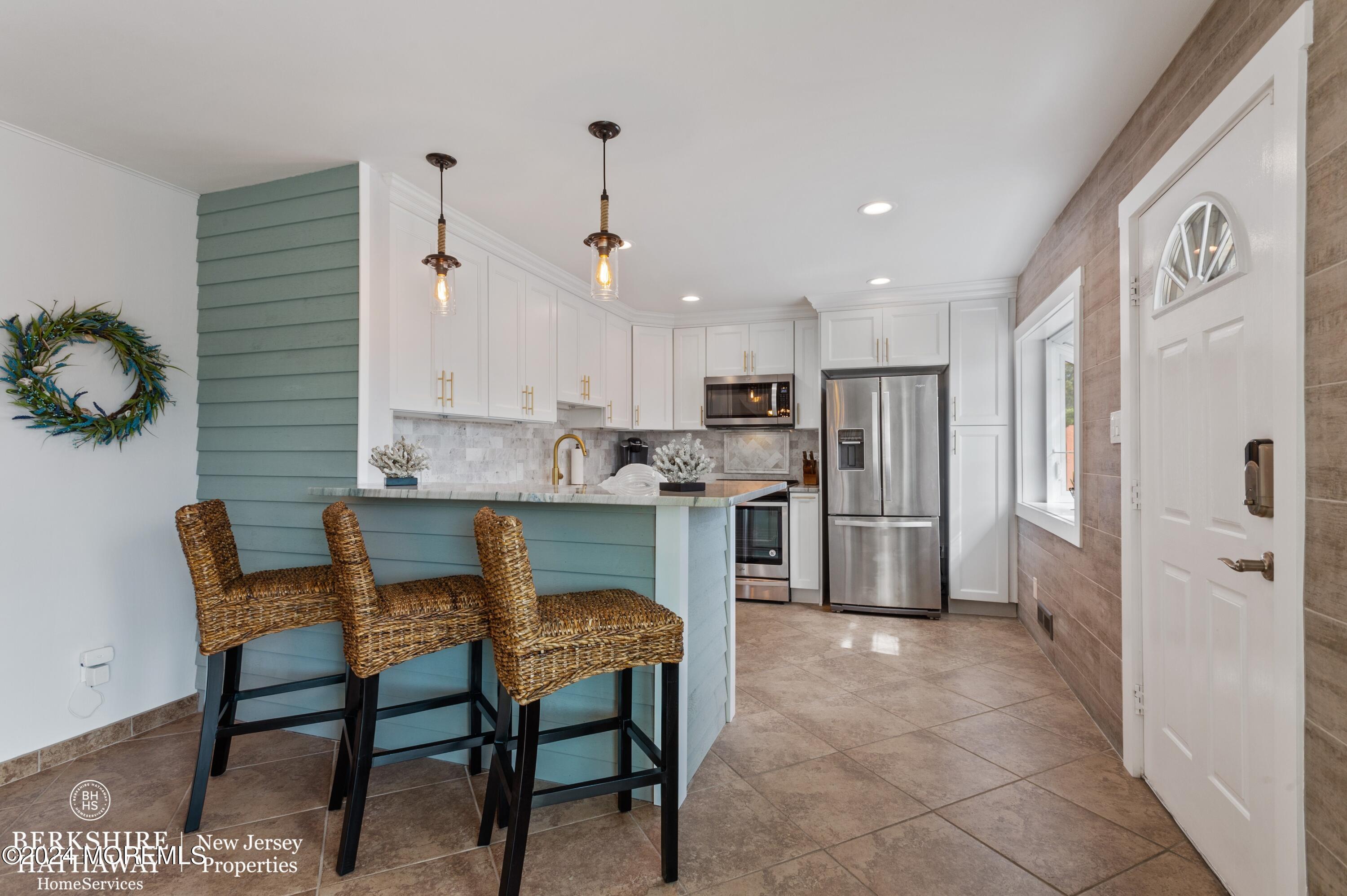 a kitchen with refrigerator and cabinets