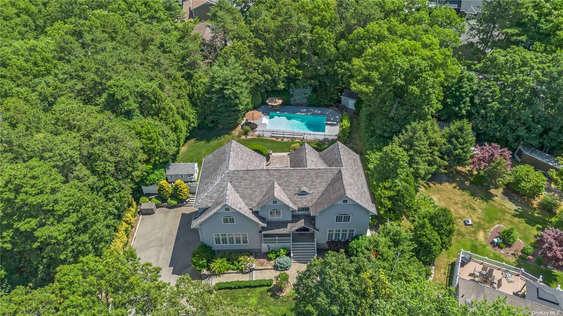 an aerial view of a house with a yard plants and large tree