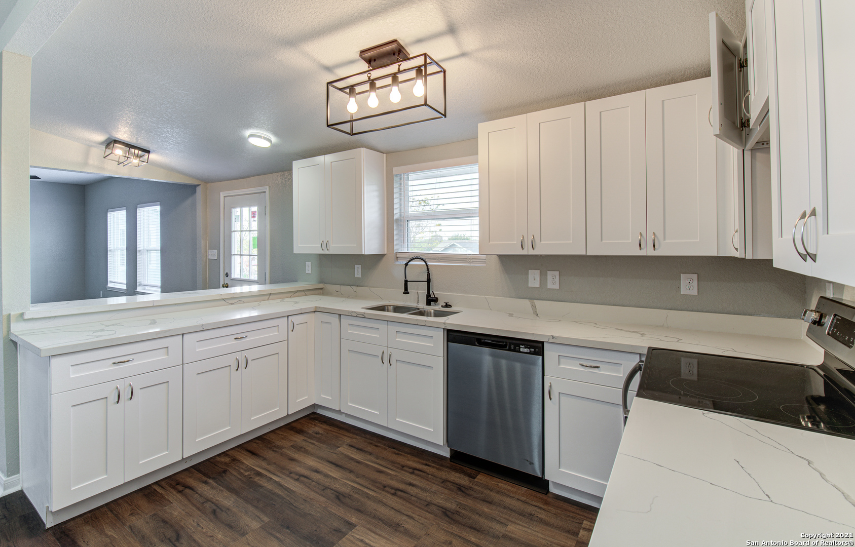 a kitchen with a sink cabinets and window