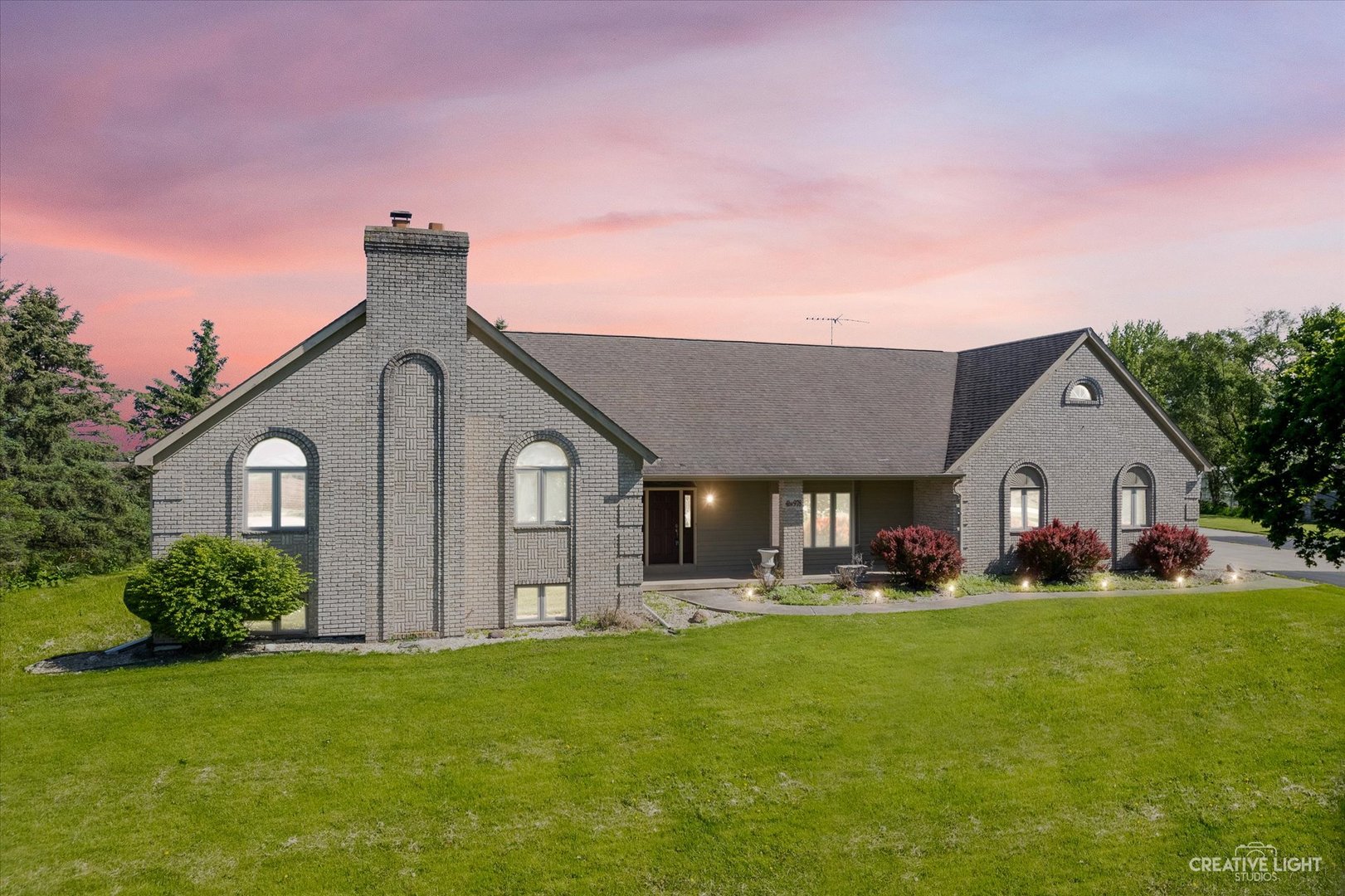 a front view of house with yard and green space