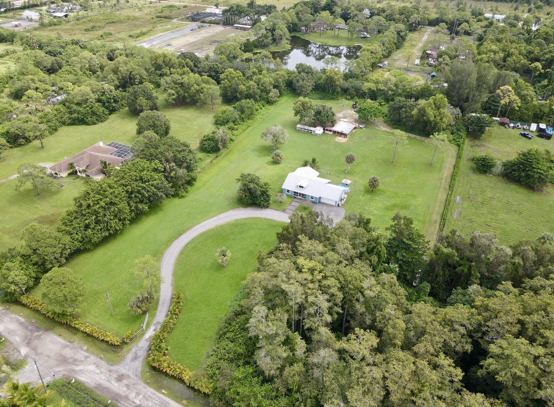 an aerial view of a residential houses with outdoor space and street view