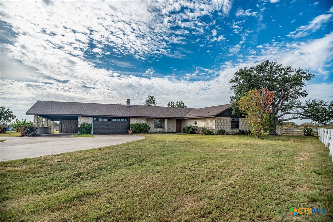 a front view of house with yard and trees