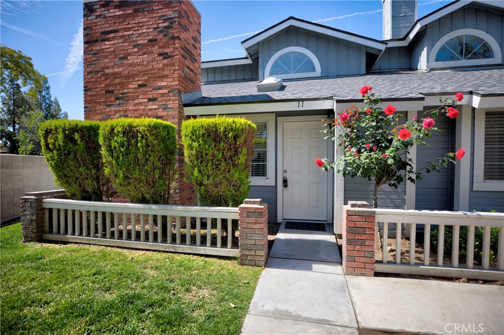 a view of a house with wooden fence