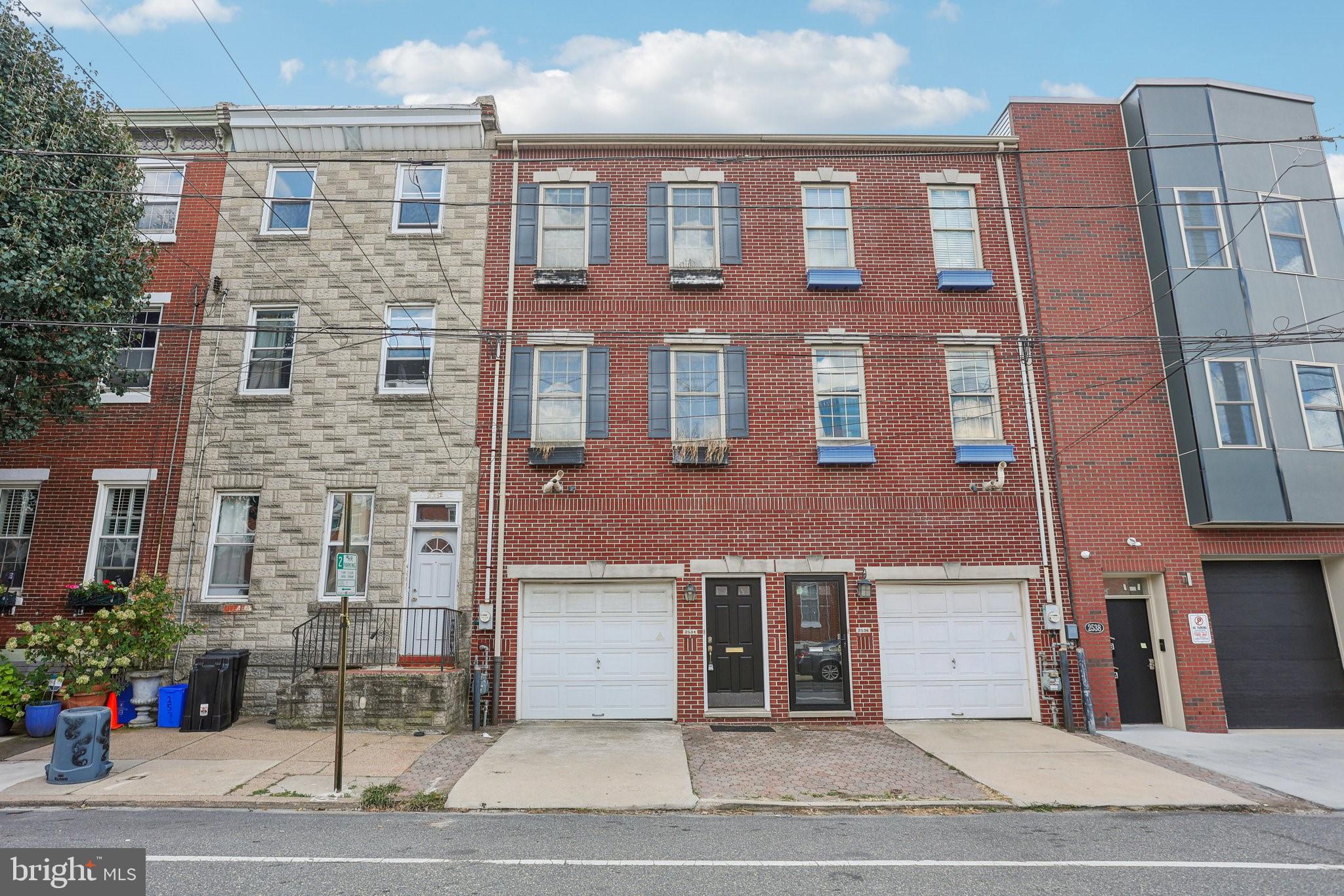 a view of a brick building next to a yard