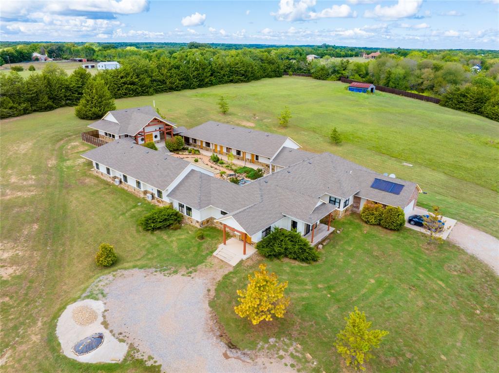 an aerial view of a house with yard swimming pool and outdoor seating