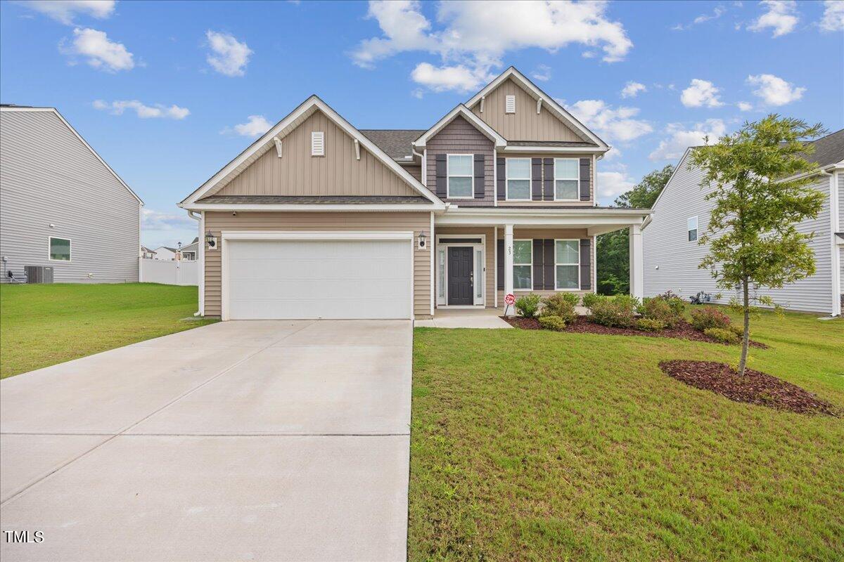 a front view of a house with a yard and garage