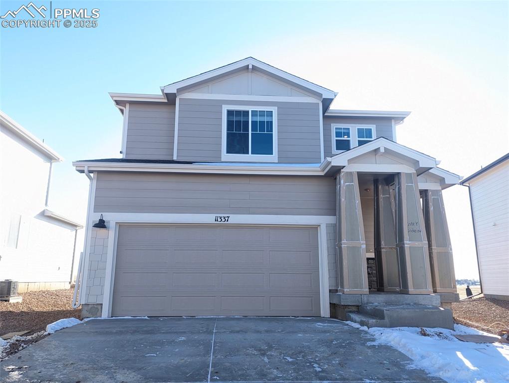 View of front facade featuring a garage