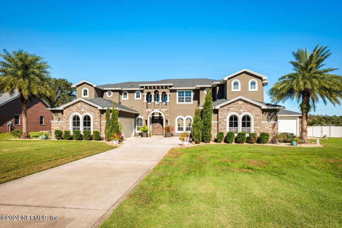 a front view of a house with a garden