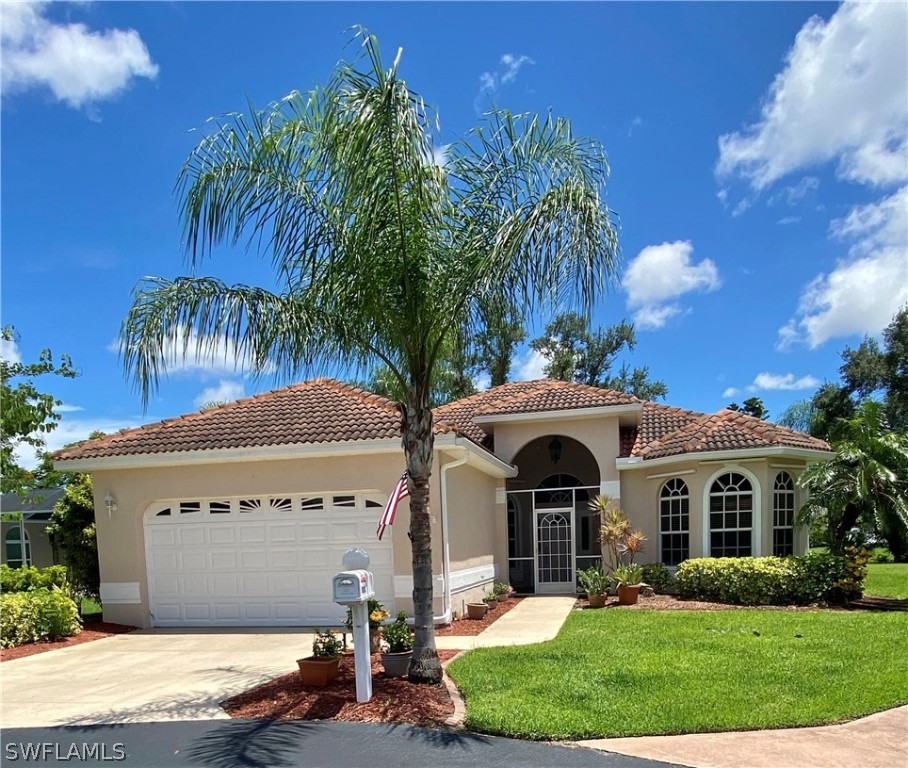 a front view of a house with a garden and a yard