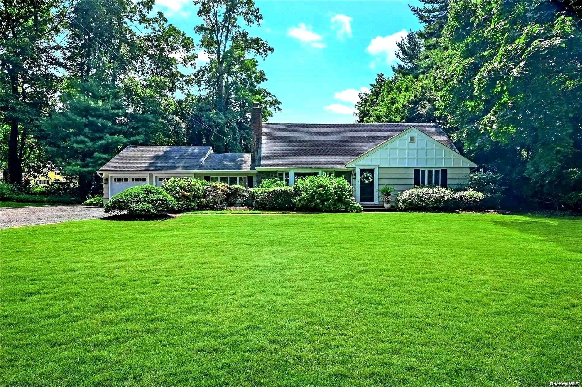 a front view of house with yard and green space