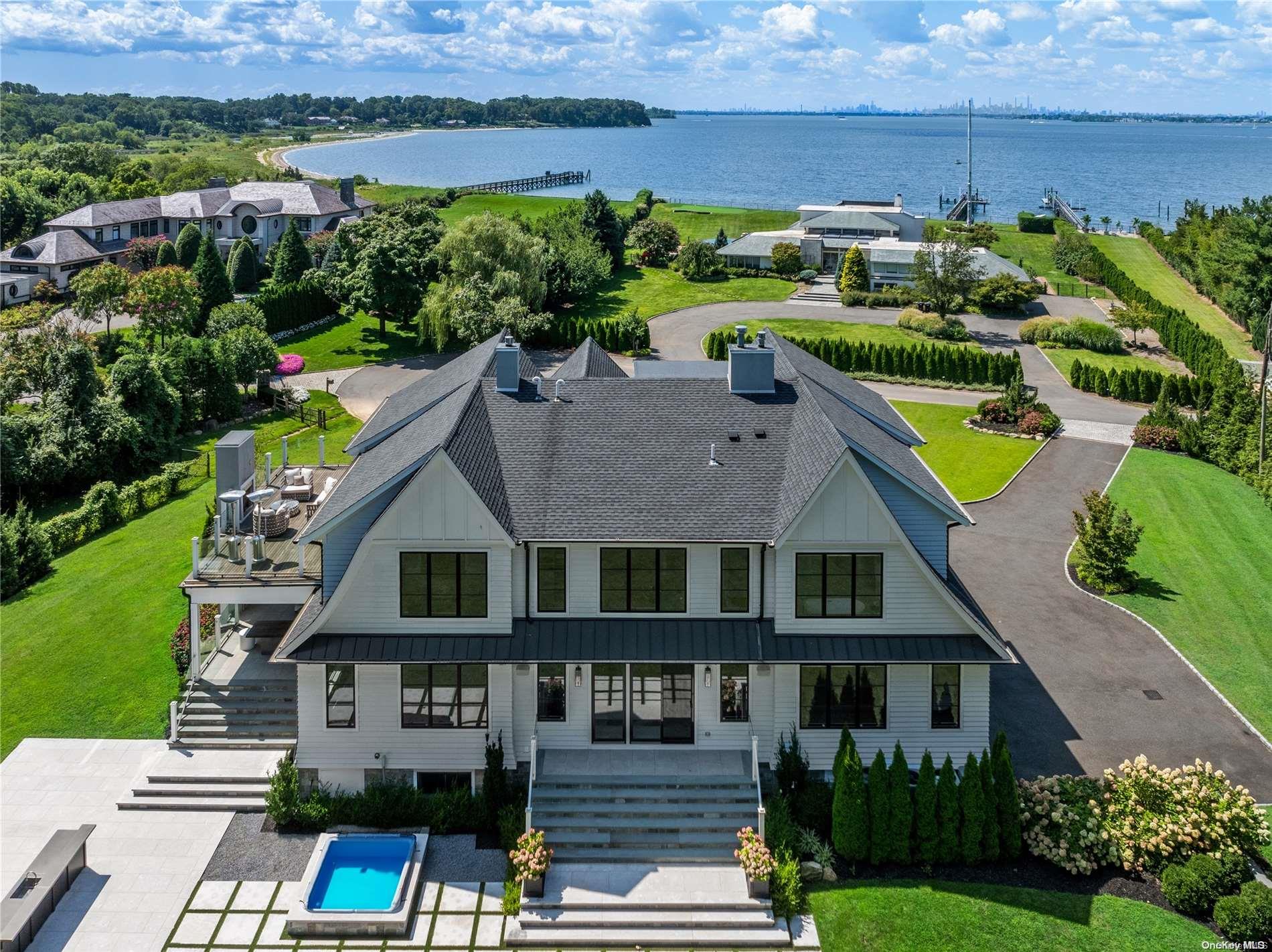 an aerial view of a house with a garden and lake view