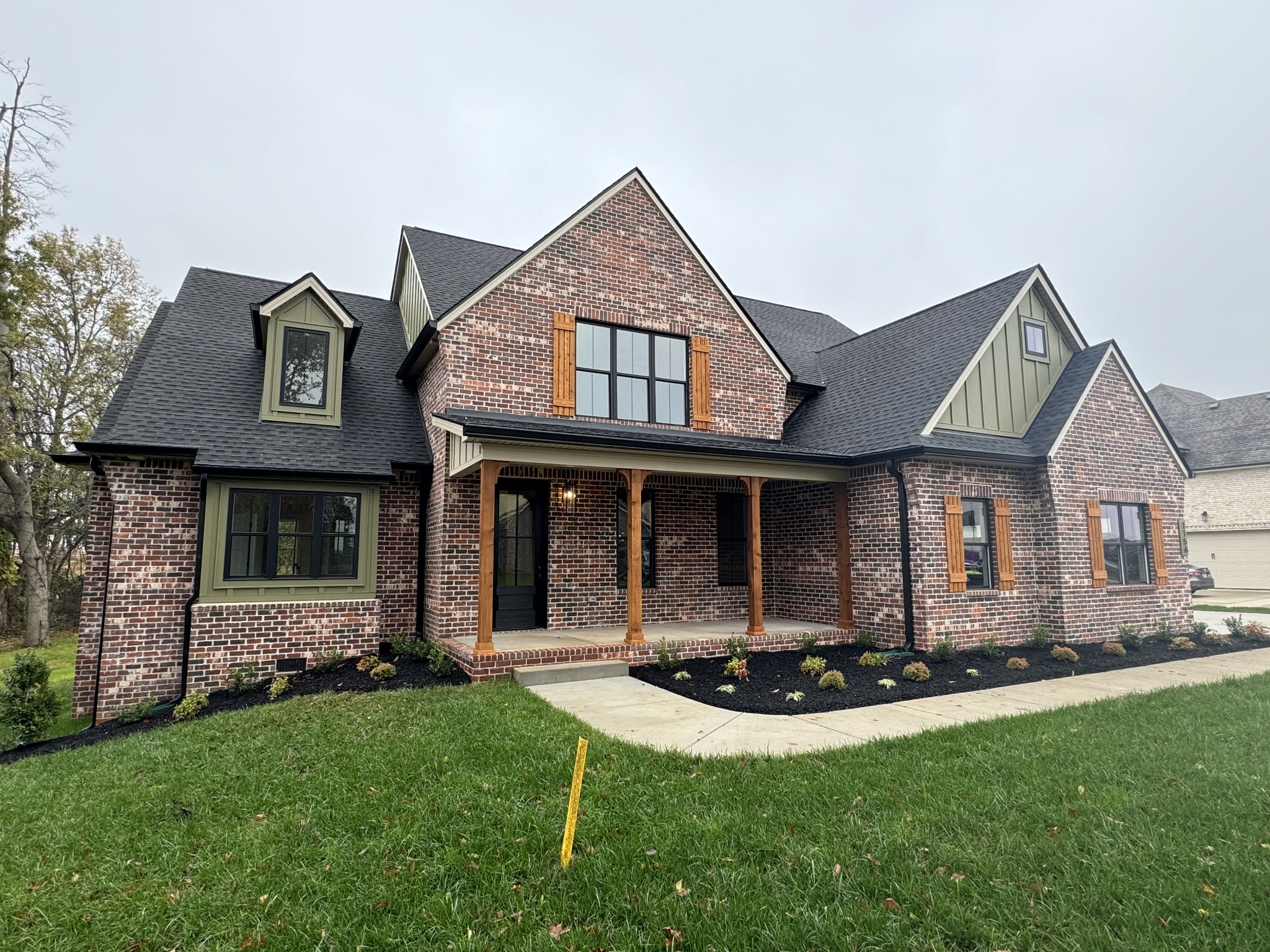 a front view of a house with a yard and porch