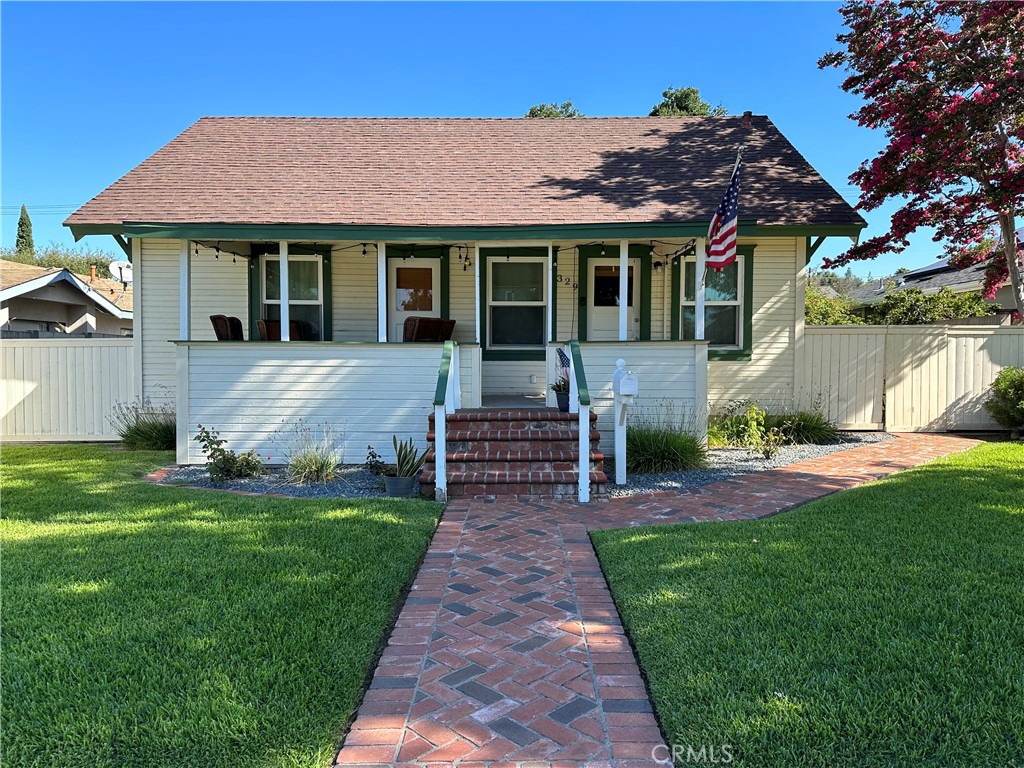 a front view of a house with a garden and yard